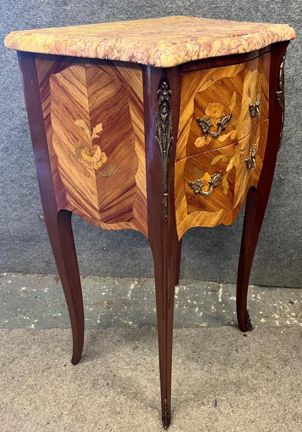 A pair of French Louis XV style bedside chests featuring floral marquetry inlay, curved cabriole legs, decorative metal mounts, and shaped pink marble tops. View VI