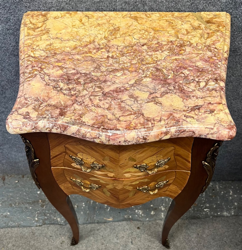 A pair of French Louis XV style bedside chests featuring floral marquetry inlay, curved cabriole legs, decorative metal mounts, and shaped pink marble tops. View VII