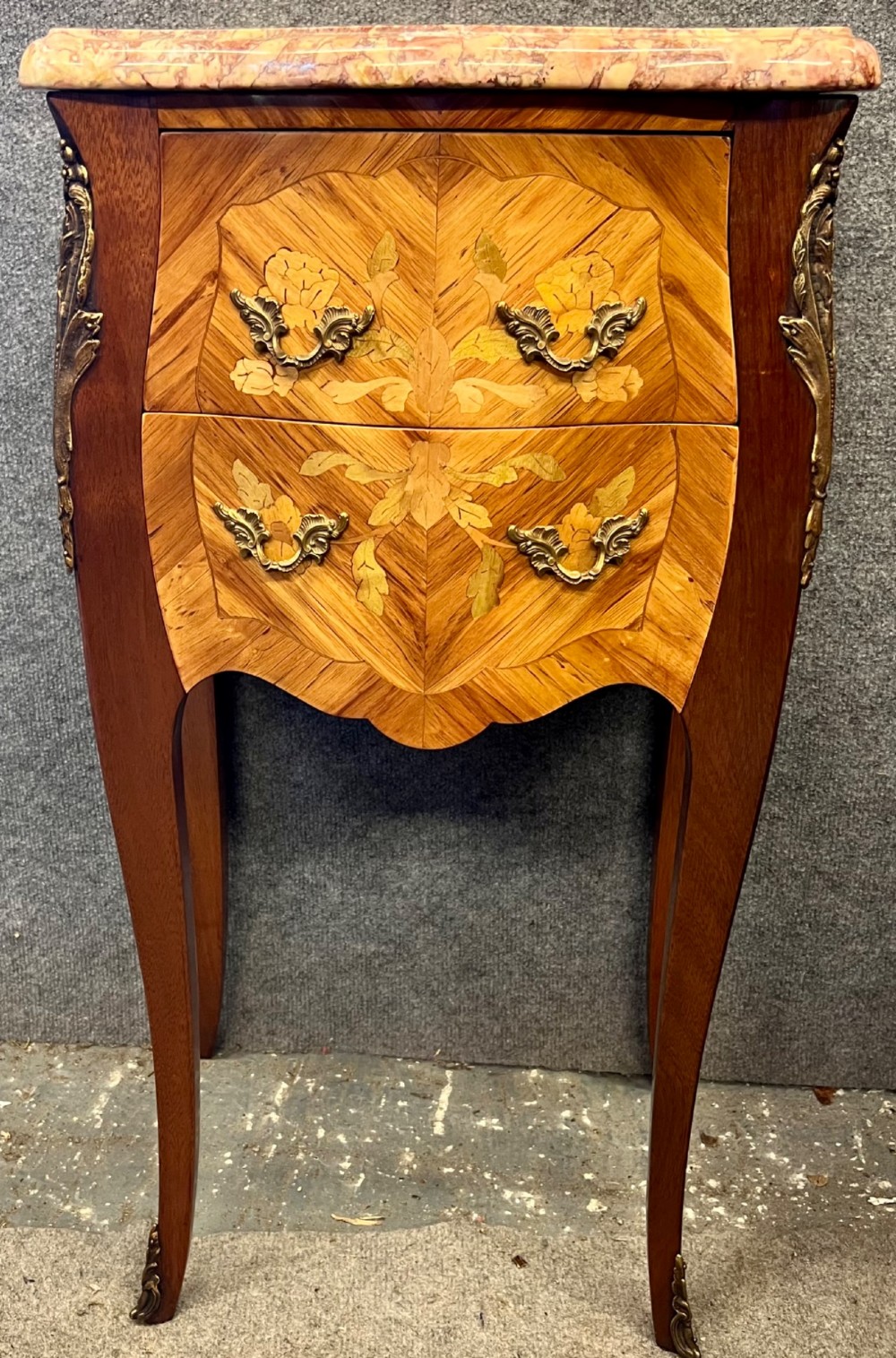 A pair of French Louis XV style bedside chests featuring floral marquetry inlay, curved cabriole legs, decorative metal mounts, and shaped pink marble tops. View VIII