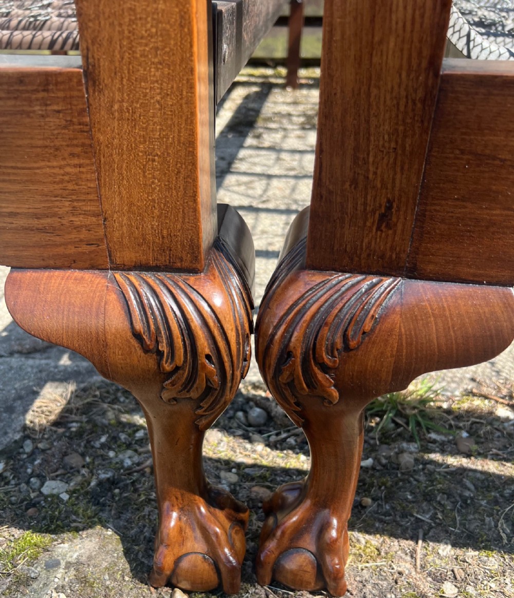 A pair of antique Chippendale style mahogany single bed frames featuring carved pierced back splats, yoke crest rails, and cabriole legs ending in claw and ball feet. View II