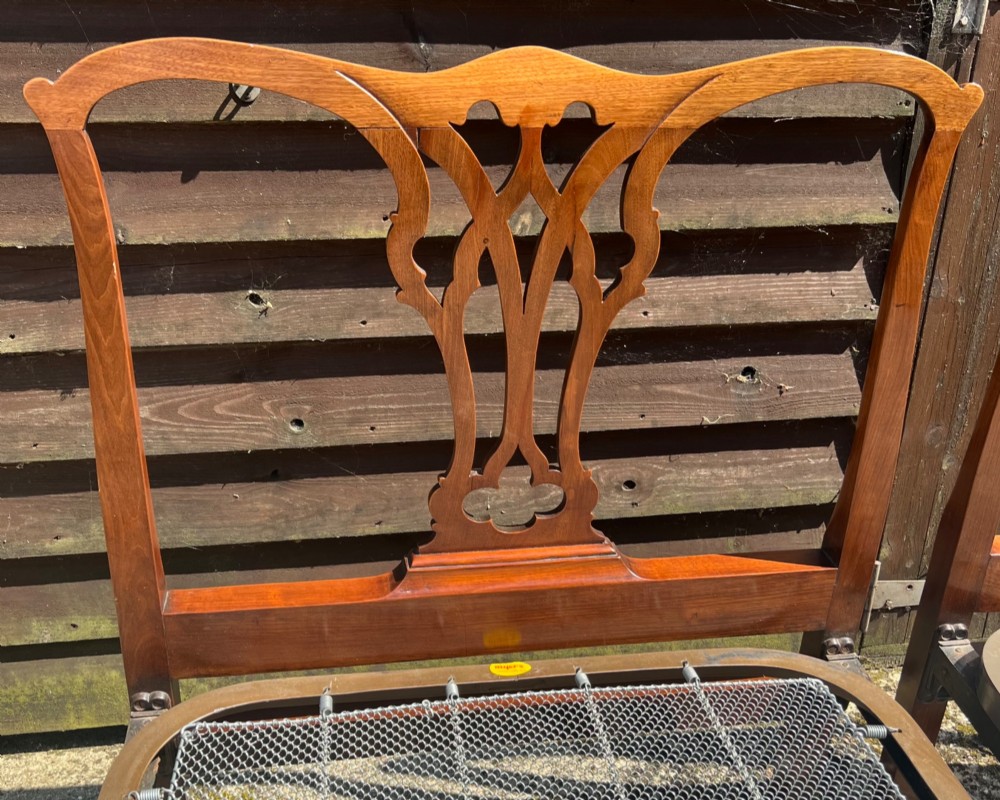 A pair of antique Chippendale style mahogany single bed frames featuring carved pierced back splats, yoke crest rails, and cabriole legs ending in claw and ball feet. View III
