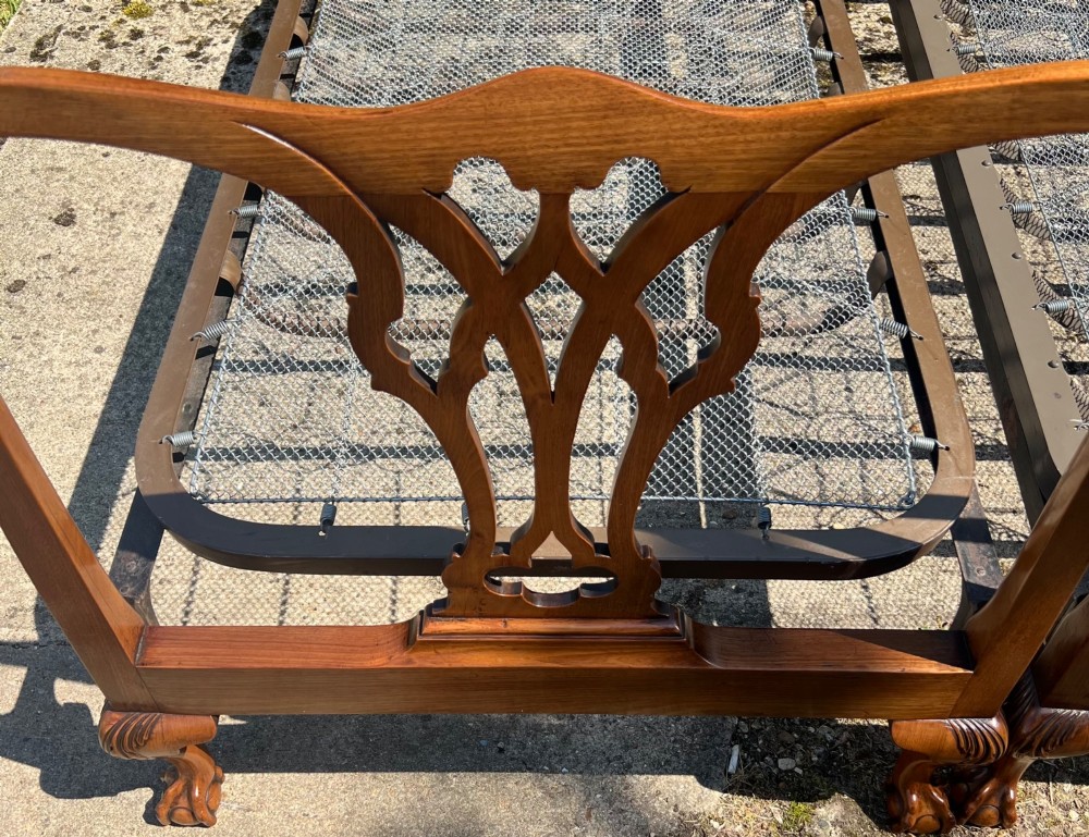 A pair of antique Chippendale style mahogany single bed frames featuring carved pierced back splats, yoke crest rails, and cabriole legs ending in claw and ball feet. View XIII
