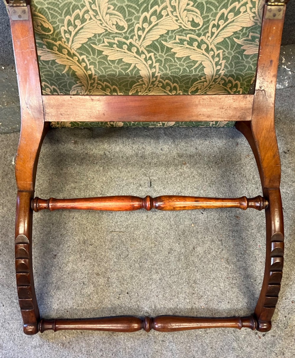 A Victorian campaign adjustable wooden backrest frame upholstered in patterned green fabric with notched timber ratchets for support. View II