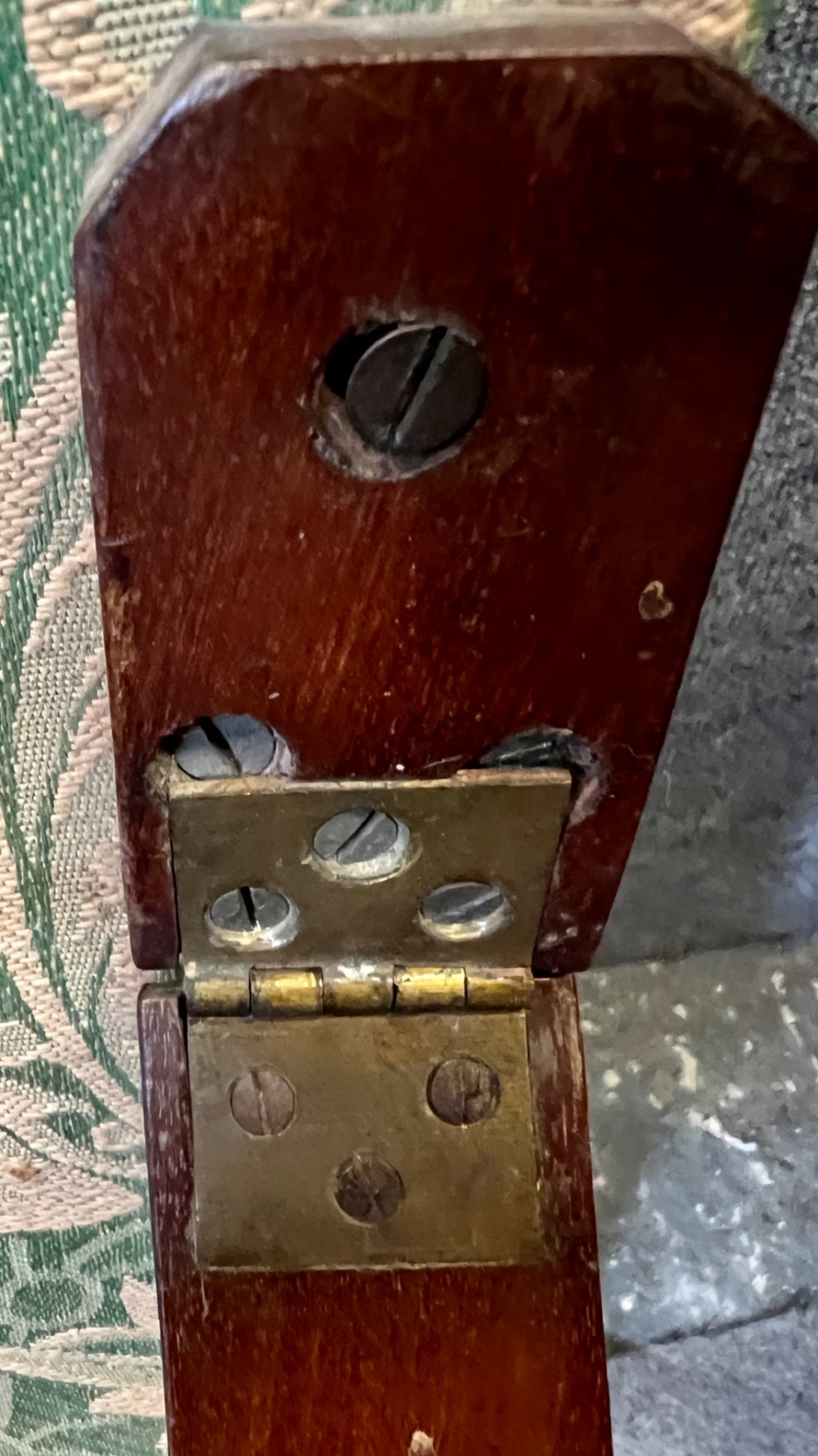 A Victorian campaign adjustable wooden backrest frame upholstered in patterned green fabric with notched timber ratchets for support. View V