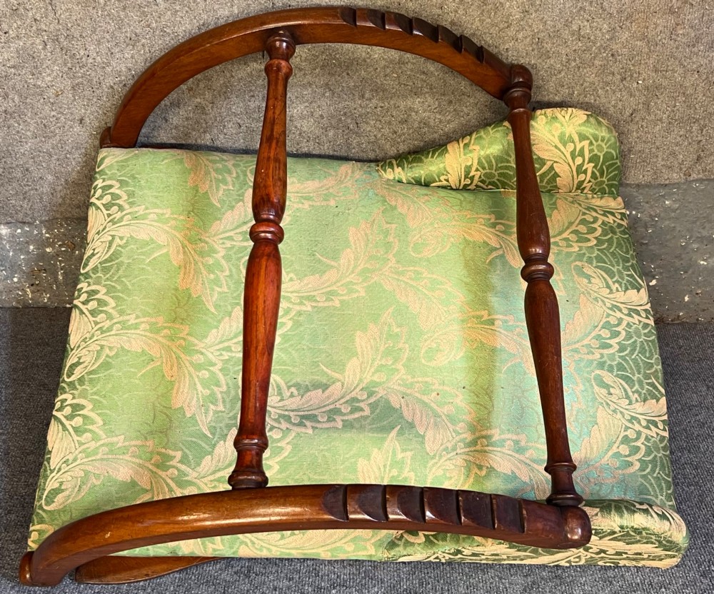 A Victorian campaign adjustable wooden backrest frame upholstered in patterned green fabric with notched timber ratchets for support. View VII