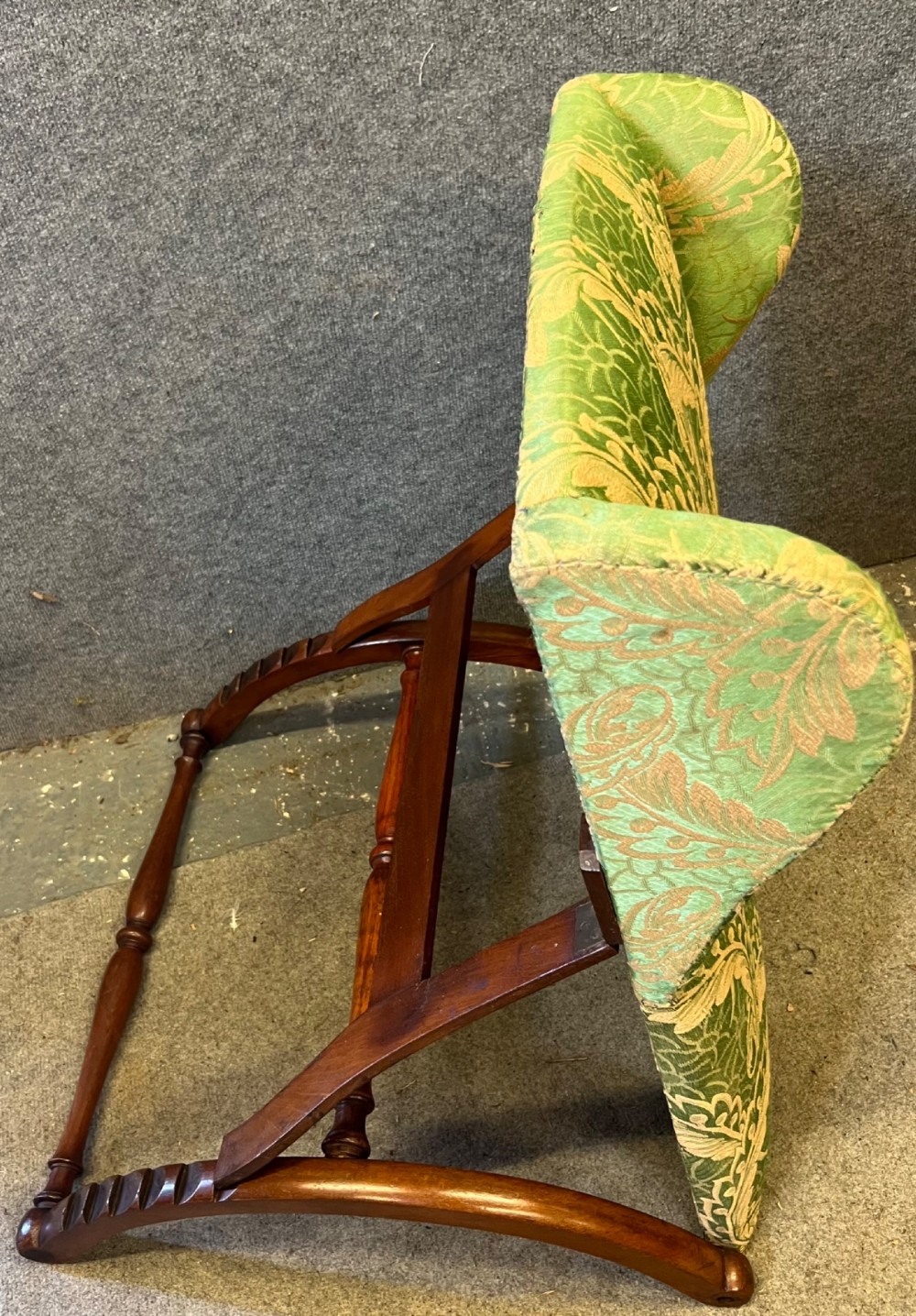 A Victorian campaign adjustable wooden backrest frame upholstered in patterned green fabric with notched timber ratchets for support. View VIII