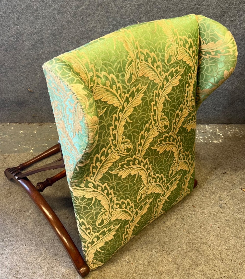 A Victorian campaign adjustable wooden backrest frame upholstered in patterned green fabric with notched timber ratchets for support. View X