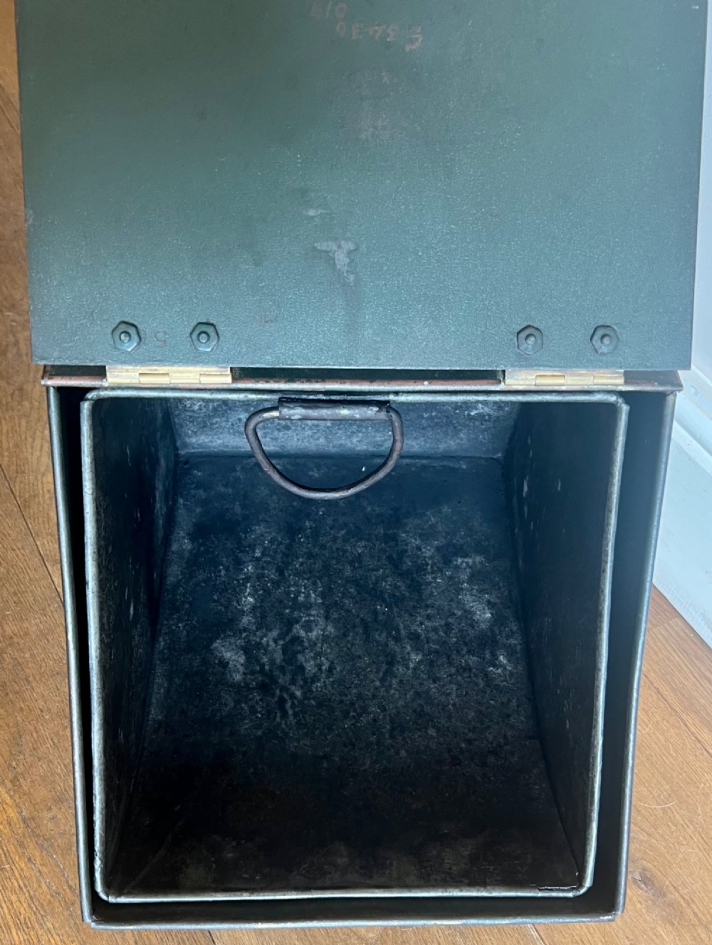 An antique dark green toleware coal scuttle featuring a slant front with a hand-painted bird and floral motif, brass hinges, and a brass top handle. View VII