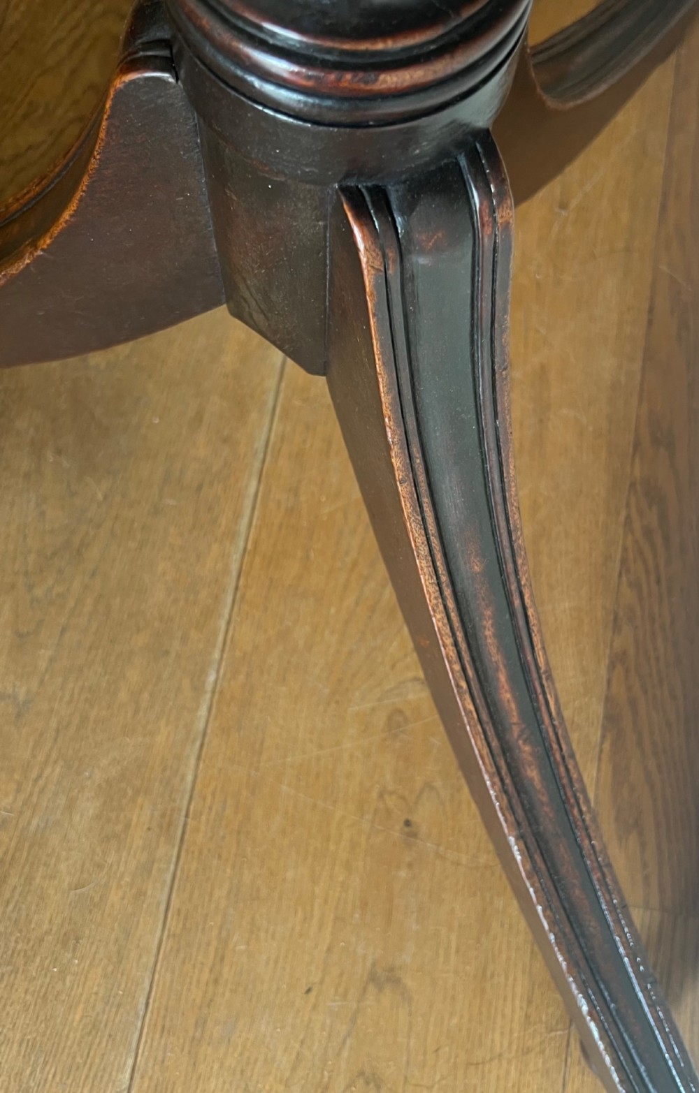 A George III mahogany tilt-top table featuring an octagonal top set on a reeded turned column and a splayed tripod base. View VIII