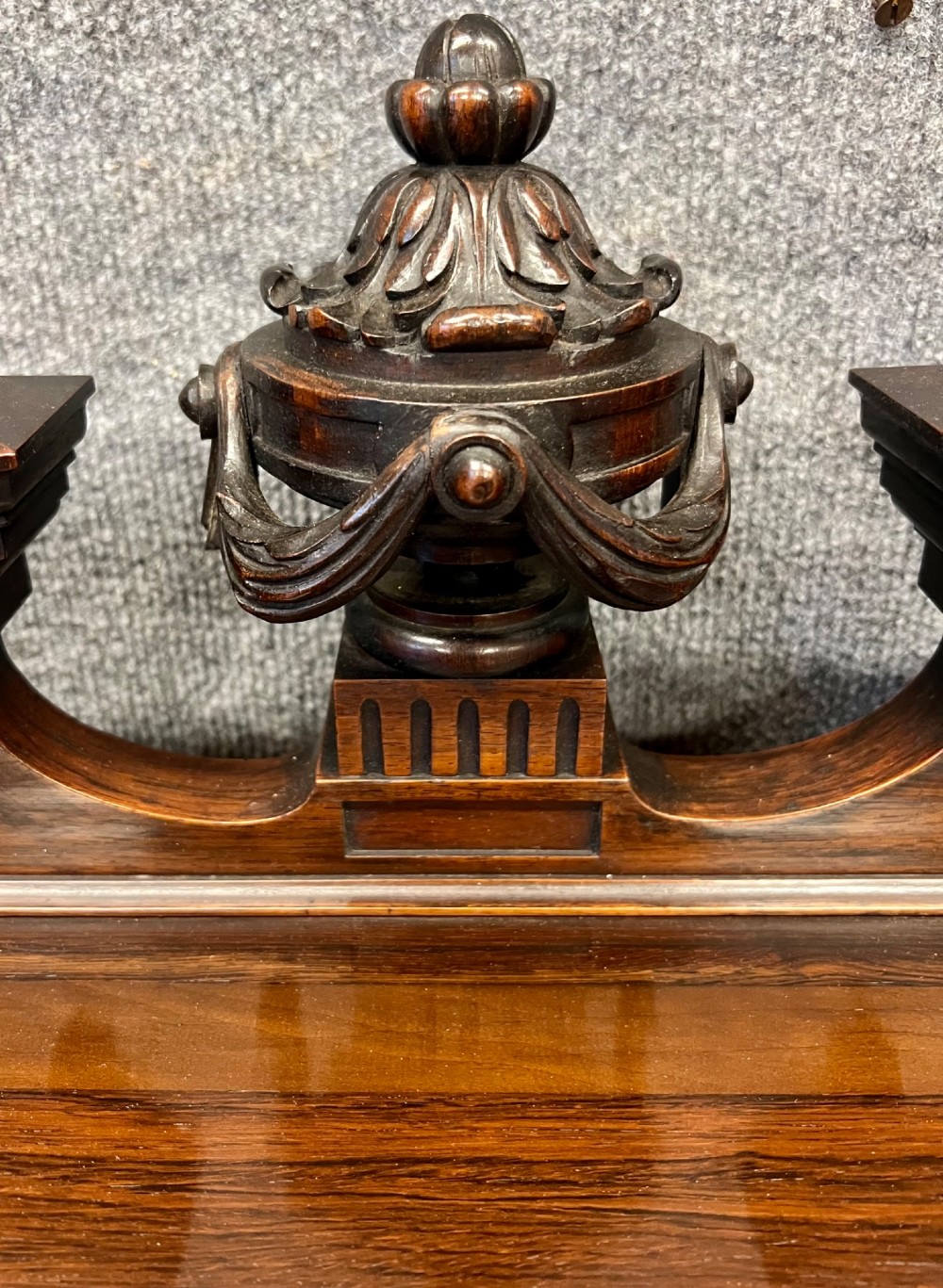 A Victorian dark walnut open bookcase with two carved drawers, open shelves, fluted pilasters, and a decorative pediment top featuring a central urn finial. View II