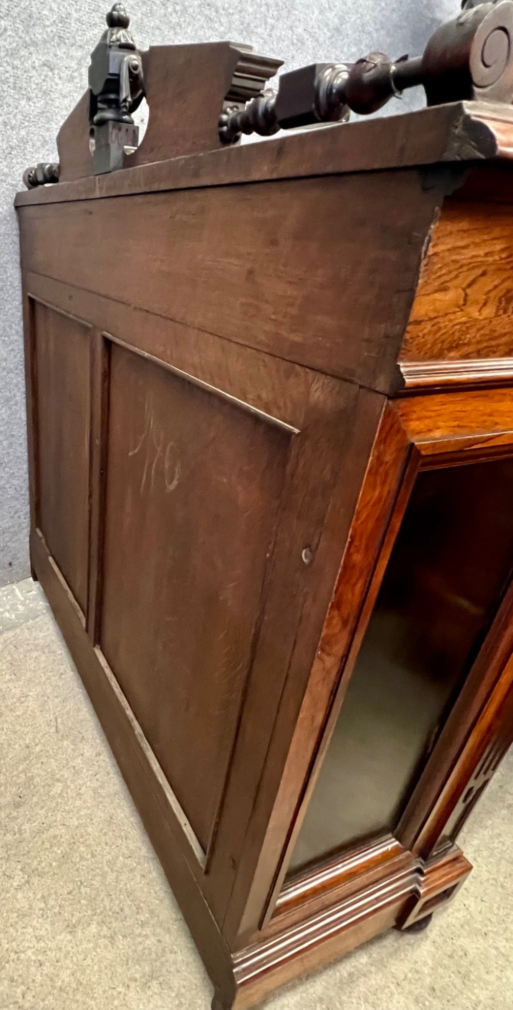 A Victorian dark walnut open bookcase with two carved drawers, open shelves, fluted pilasters, and a decorative pediment top featuring a central urn finial. View IX