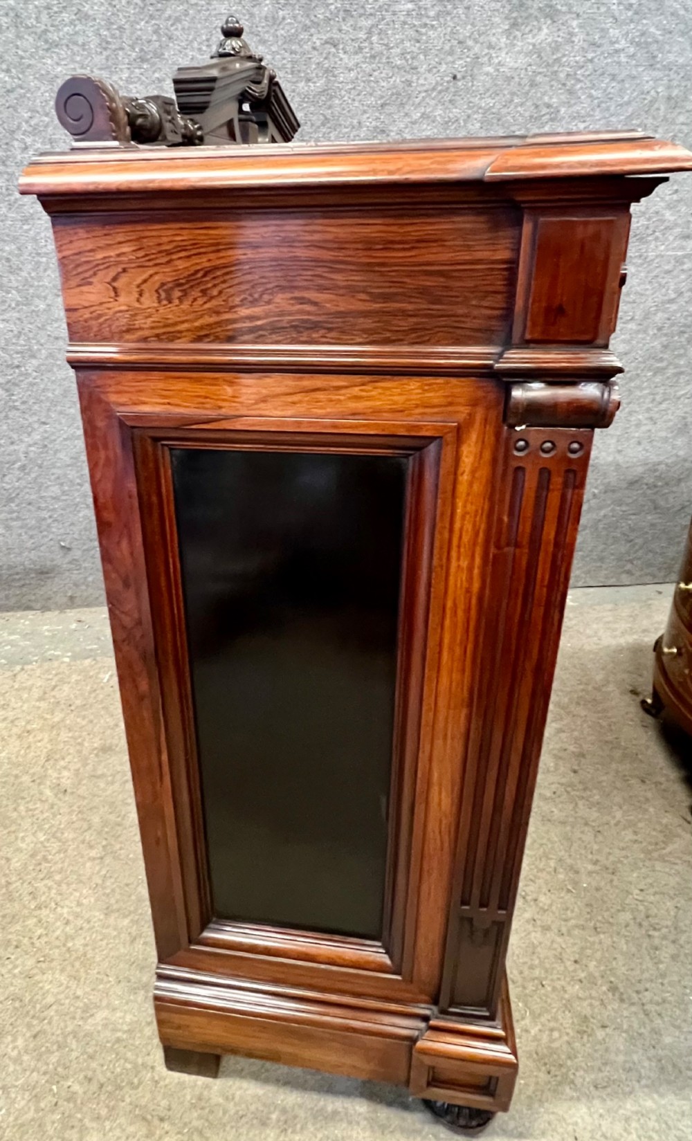 A Victorian dark walnut open bookcase with two carved drawers, open shelves, fluted pilasters, and a decorative pediment top featuring a central urn finial. View X