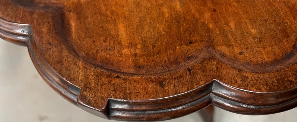 A George III mahogany tripod table featuring a scalloped piecrust rim, an inlaid chessboard top, a turned pedestal, and three cabriole legs. View V