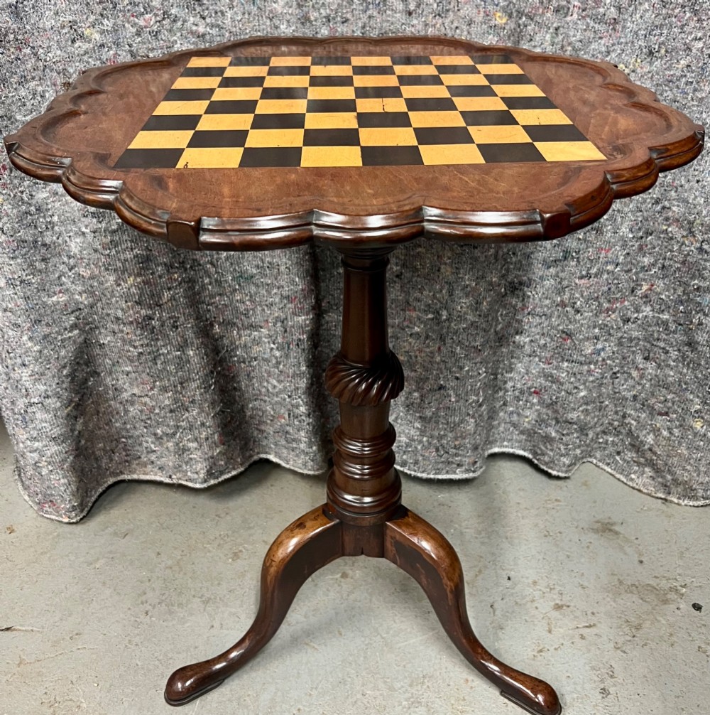 A George III mahogany tripod table featuring a scalloped piecrust rim, an inlaid chessboard top, a turned pedestal, and three cabriole legs. View VII