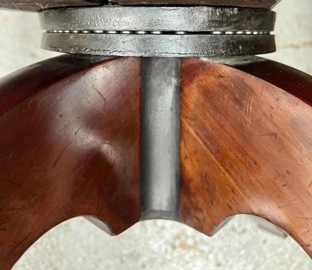 A Victorian mahogany revolving desk chair with tan leather padded seating, brass stud detailing, and a turned spindle gallery backrest. View VII