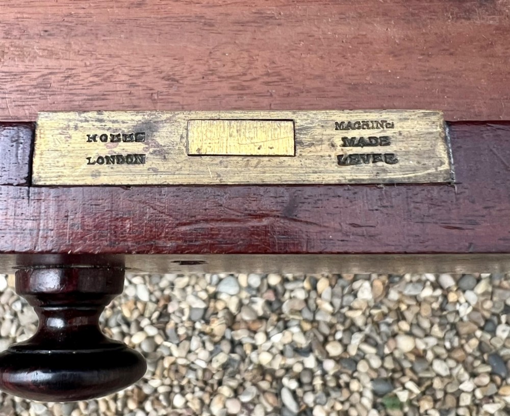 A nineteenth-century mahogany side table with a low gallery back, two frieze drawers, and turned reeded legs on brass castors. View VII
