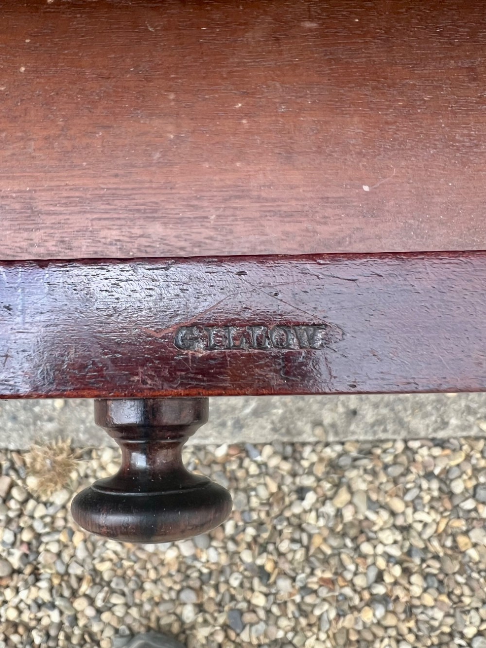 A nineteenth-century mahogany side table with a low gallery back, two frieze drawers, and turned reeded legs on brass castors. View XIV