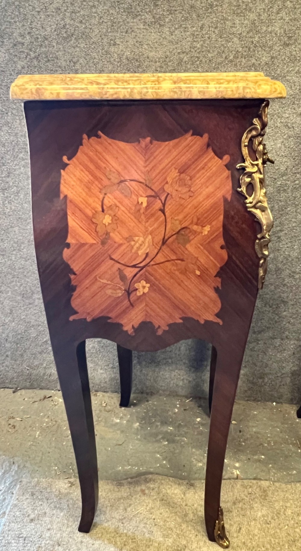 A pair of French Louis XV style bedside tables featuring marble tops, two floral marquetry drawers, gilt-bronze mounts, and slender cabriole legs. View VI