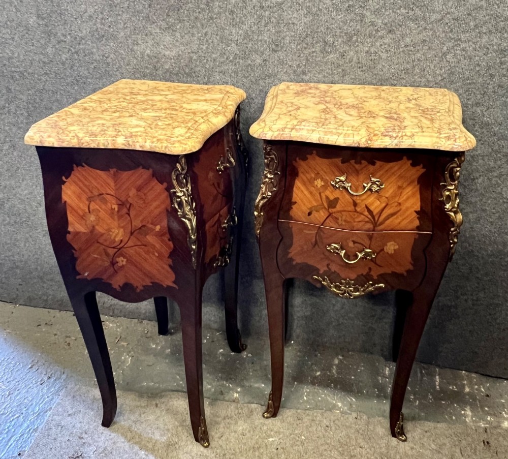 A pair of French Louis XV style bedside tables featuring marble tops, two floral marquetry drawers, gilt-bronze mounts, and slender cabriole legs. View VIII
