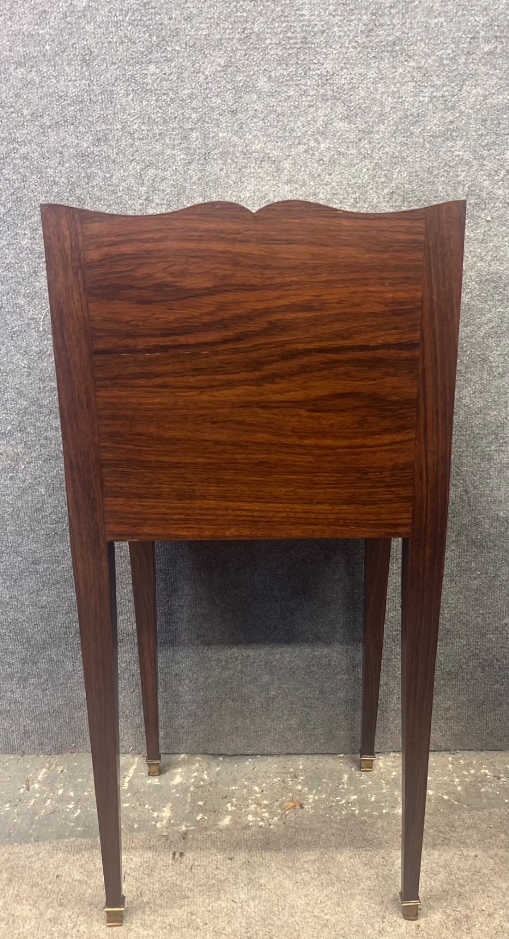 A pair of slender French bedside cabinets featuring chevron wood parquetry doors, white marble tops, and long tapered legs with brass feet. View V