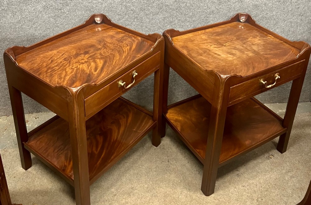 A matching pair of Georgian style mahogany bedside tables featuring flame mahogany tops with shaped gallery edges, single drawers, and open lower shelves. View VII