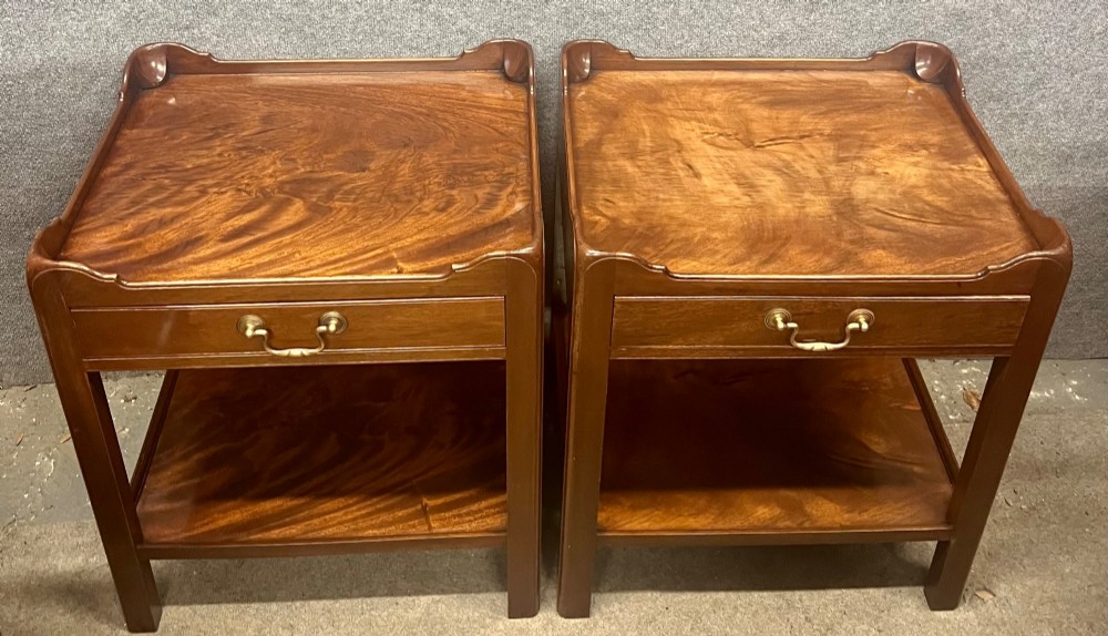A matching pair of Georgian style mahogany bedside tables featuring flame mahogany tops with shaped gallery edges, single drawers, and open lower shelves. View VIII