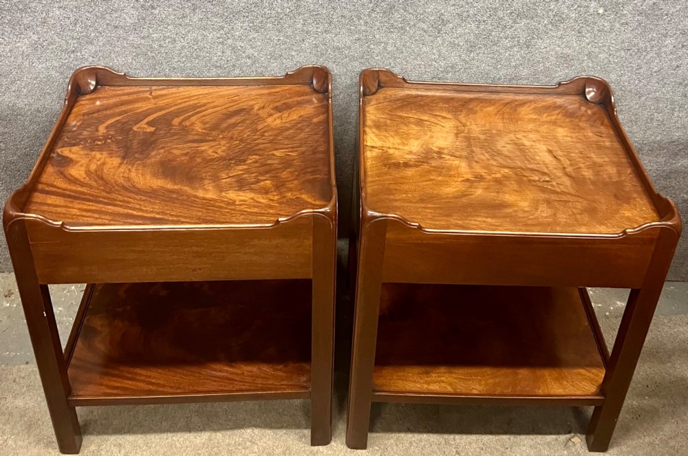 A matching pair of Georgian style mahogany bedside tables featuring flame mahogany tops with shaped gallery edges, single drawers, and open lower shelves. View IX