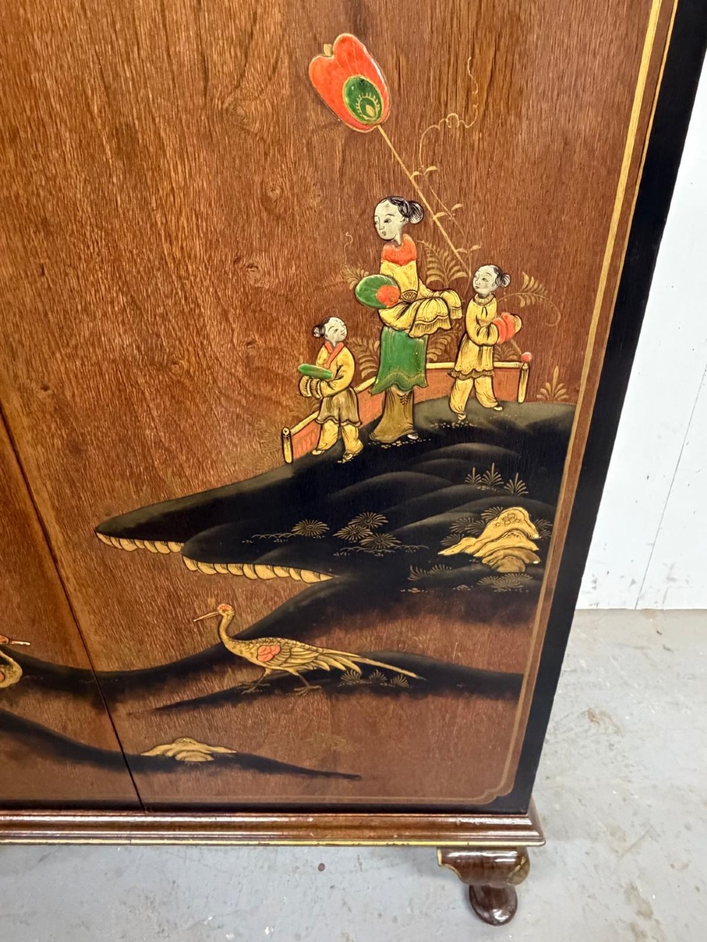 A two-door wooden compactum wardrobe decorated with hand-painted Chinoiserie scenes, pagodas, and figures set within dark lacquered borders. View VI