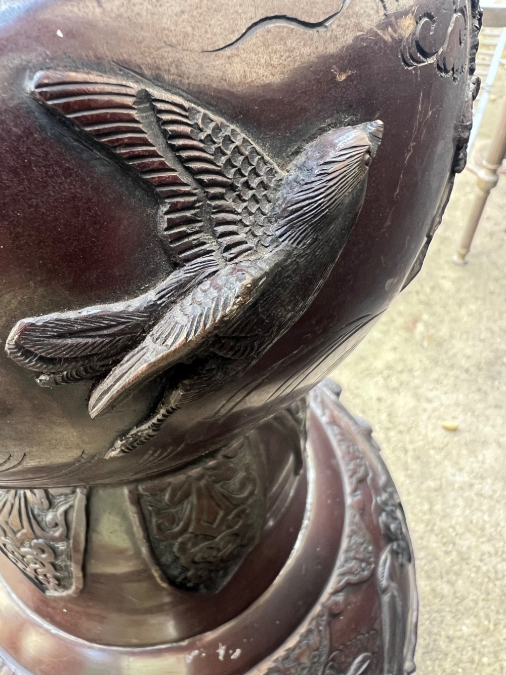 A tall Japanese Meiji period dark bronze floor lamp featuring high-relief relief castings of birds and floral branches along a baluster column. View II