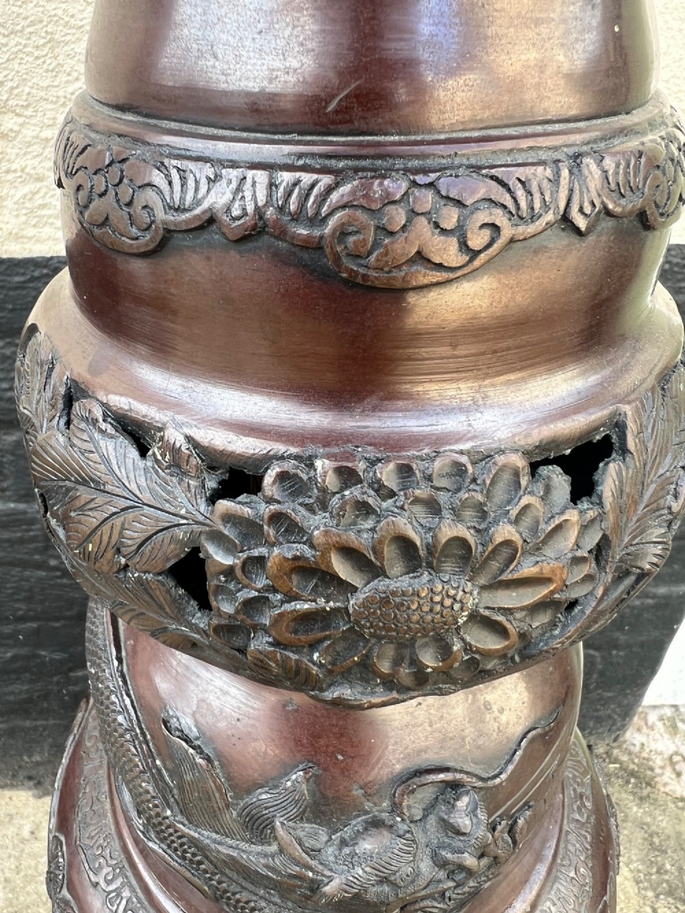 A tall Japanese Meiji period dark bronze floor lamp featuring high-relief relief castings of birds and floral branches along a baluster column. View X