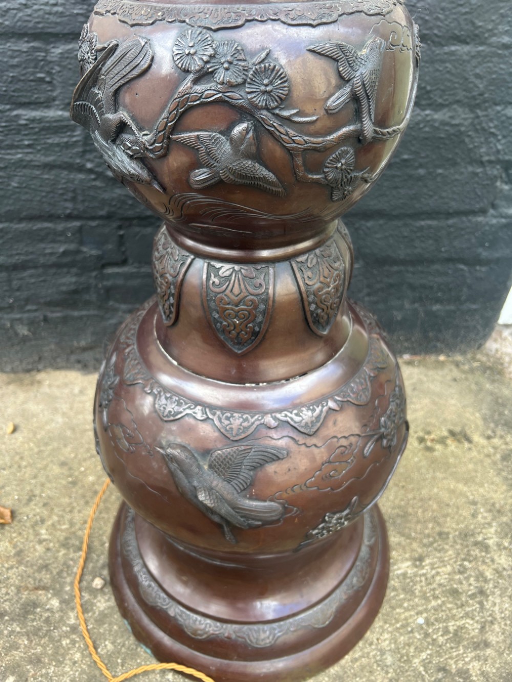 A tall Japanese Meiji period dark bronze floor lamp featuring high-relief relief castings of birds and floral branches along a baluster column. View XIII