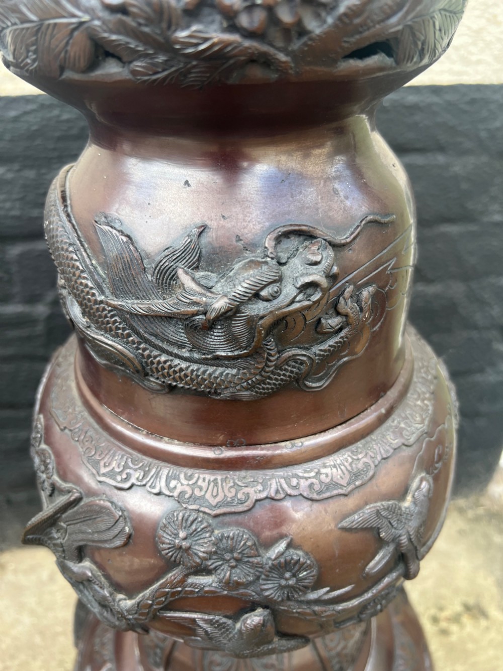 A tall Japanese Meiji period dark bronze floor lamp featuring high-relief relief castings of birds and floral branches along a baluster column. View XIV