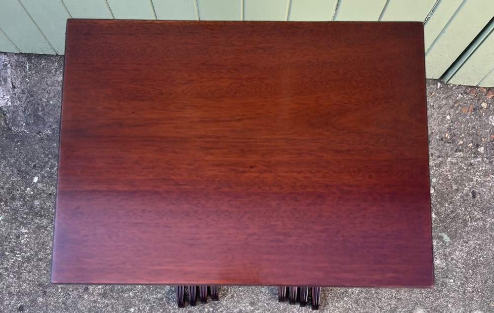 A set of four graduated Edwardian mahogany nesting tables featuring rectangular tops, slender fluted legs, and curved stretchers. View V