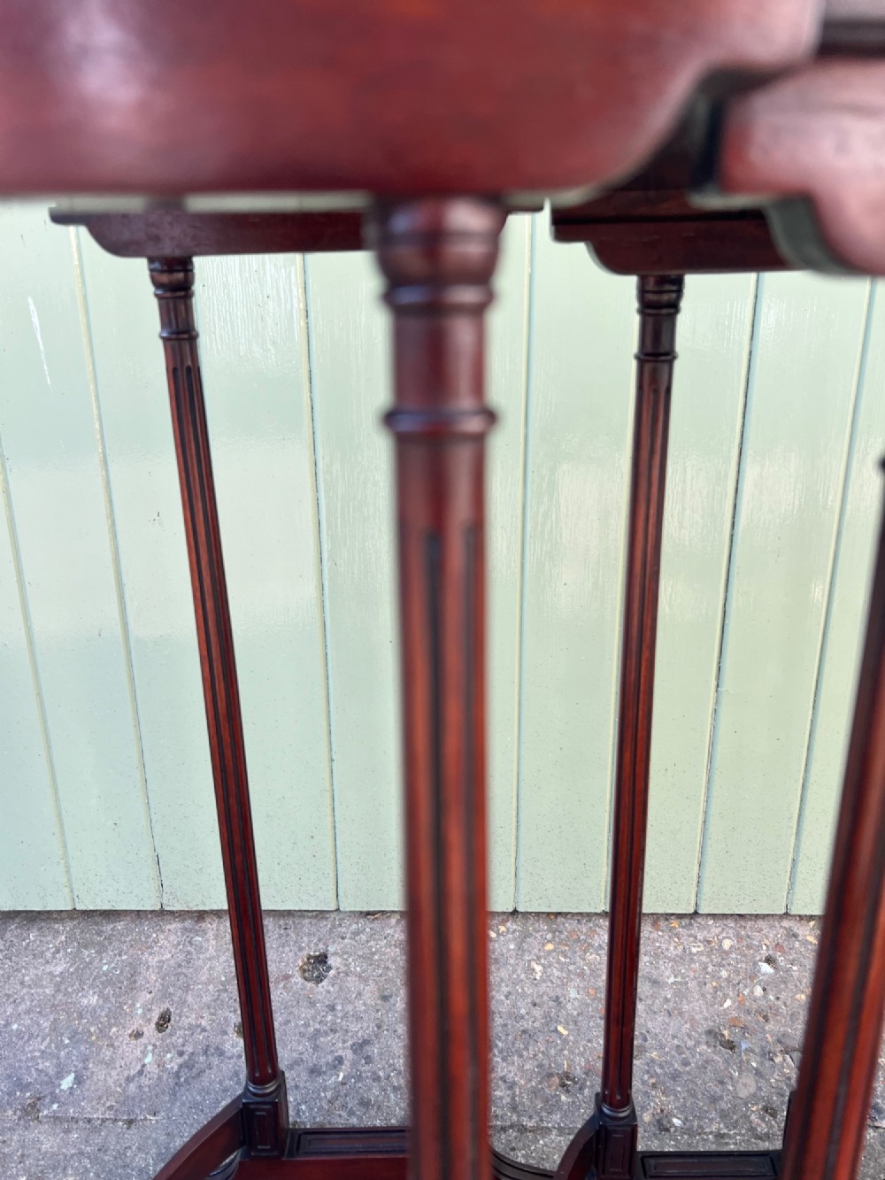 A set of four graduated Edwardian mahogany nesting tables featuring rectangular tops, slender fluted legs, and curved stretchers. View VI