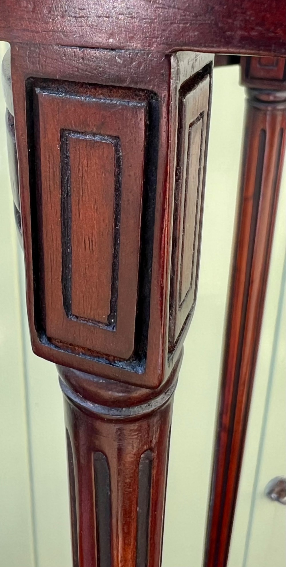 A set of four graduated Edwardian mahogany nesting tables featuring rectangular tops, slender fluted legs, and curved stretchers. View VII