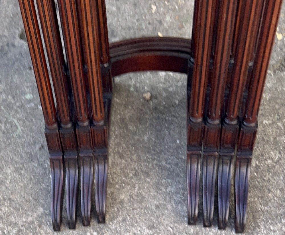 A set of four graduated Edwardian mahogany nesting tables featuring rectangular tops, slender fluted legs, and curved stretchers. View IX