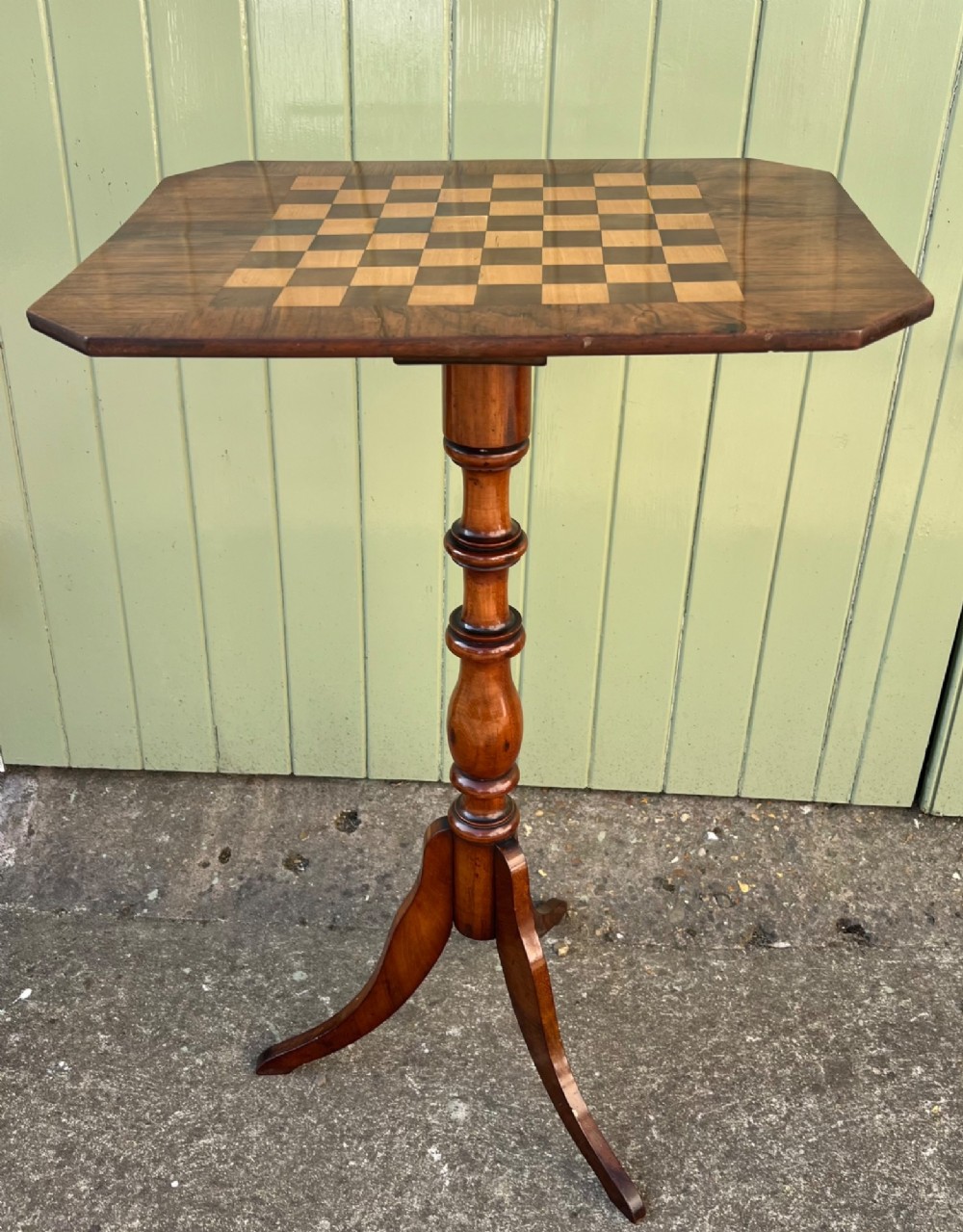 An antique rosewood chess table featuring an octagonal top inlaid with a geometric chessboard, supported by a turned central pedestal and a tripod base. View III