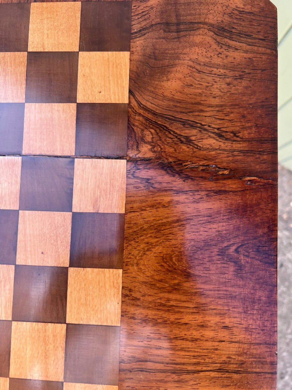 An antique rosewood chess table featuring an octagonal top inlaid with a geometric chessboard, supported by a turned central pedestal and a tripod base. View VI