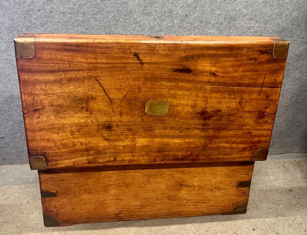 A rectangular Anglo-Indian campaign trunk crafted from warm brown wood with protective brass corner straps and metal carrying handles. View VI