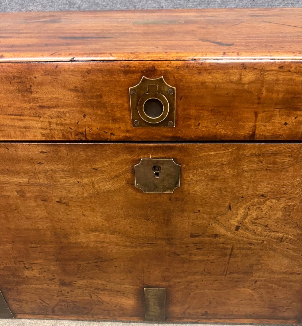 A rectangular Anglo-Indian campaign trunk crafted from warm brown wood with protective brass corner straps and metal carrying handles. View VII