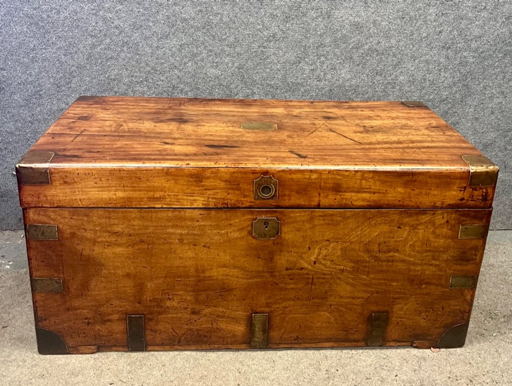 A rectangular Anglo-Indian campaign trunk crafted from warm brown wood with protective brass corner straps and metal carrying handles. View VIII
