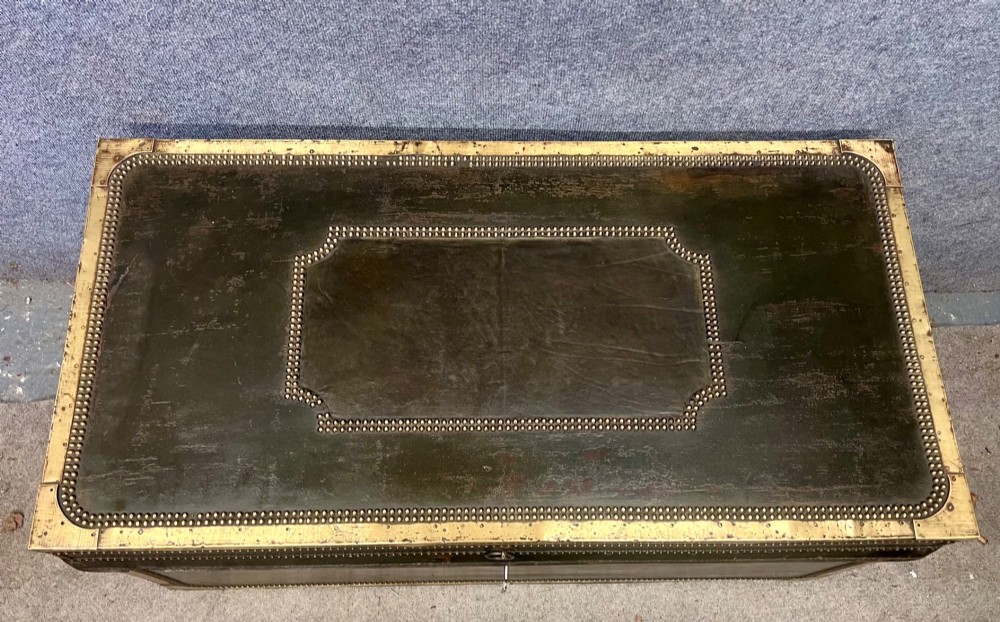 An early nineteenth-century camphor wood campaign trunk wrapped in dark olive green leather with brass stud borders, brass corner plates, side handles, and a key lock. View III