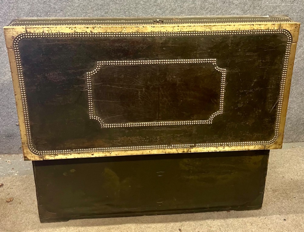 An early nineteenth-century camphor wood campaign trunk wrapped in dark olive green leather with brass stud borders, brass corner plates, side handles, and a key lock. View XI