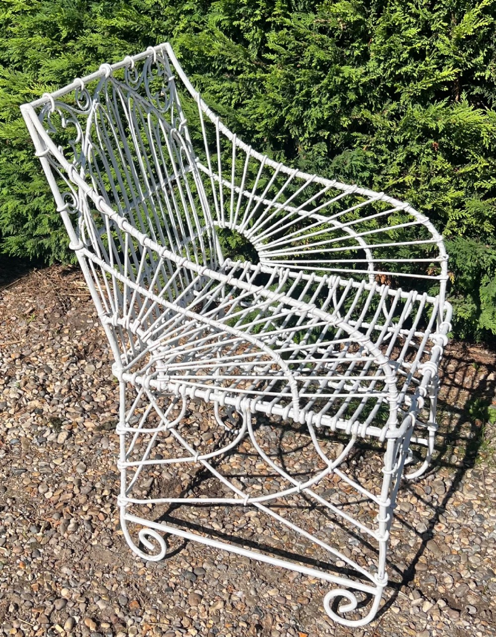 A pair of white painted iron garden chairs featuring Gothic arched backs, slatted wire seats, and scrolled feet. View IV