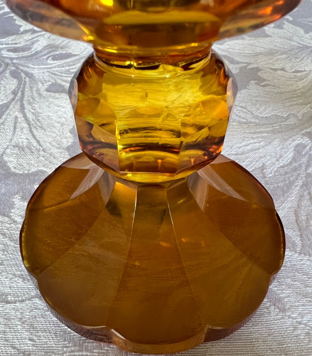 An amber glass lidded pokal vase featuring wheel-engraved woodland imagery with a stag, a faceted stem, and a stepped lid. View VIII