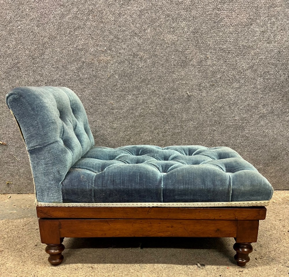 A 19th-century mahogany gout stool featuring an adjustable ratcheted frame and button-tufted blue velvet upholstery on turned feet. View III