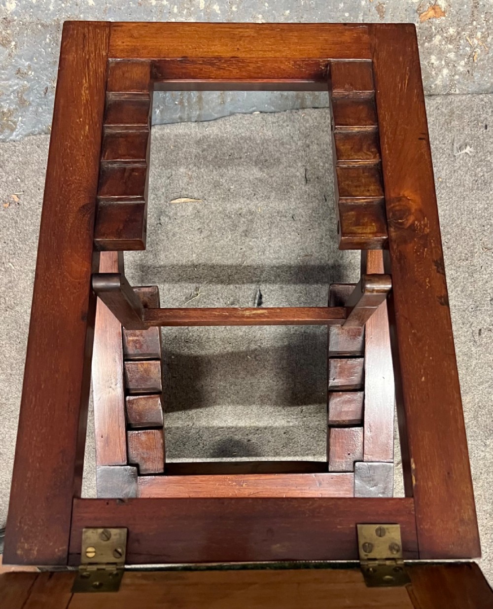 A 19th-century mahogany gout stool featuring an adjustable ratcheted frame and button-tufted blue velvet upholstery on turned feet. View IV
