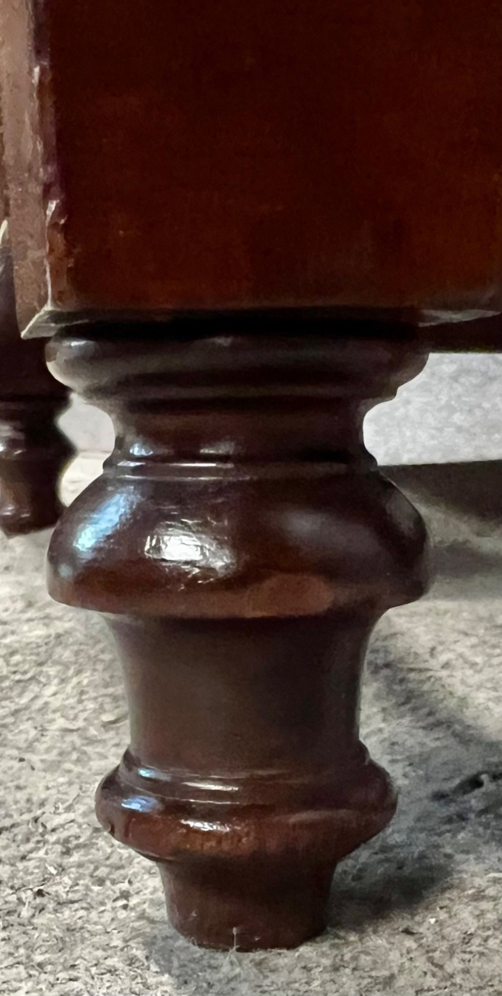 A 19th-century mahogany gout stool featuring an adjustable ratcheted frame and button-tufted blue velvet upholstery on turned feet. View V