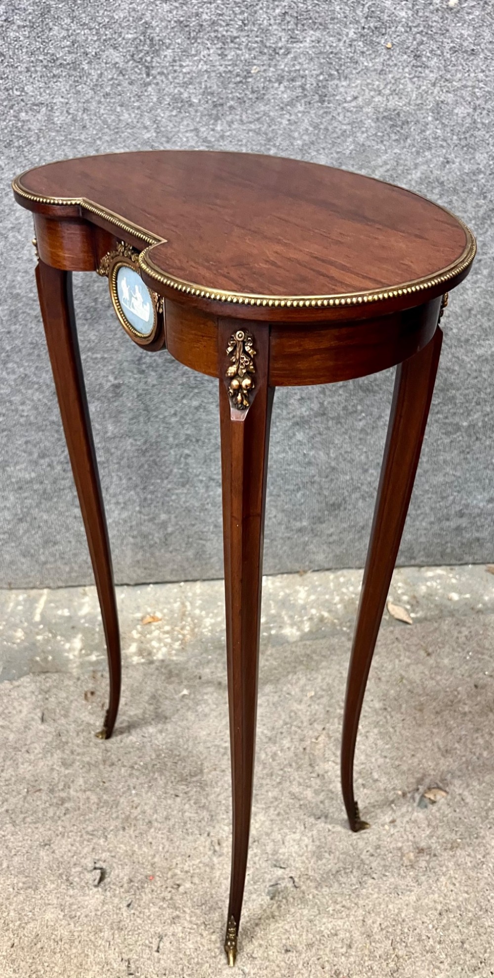 A tall mahogany kidney-shaped occasional table featuring slender cabriole legs, a beaded gilt bronze rim, and a central blue jasperware medallion framed in ormolu. View VII