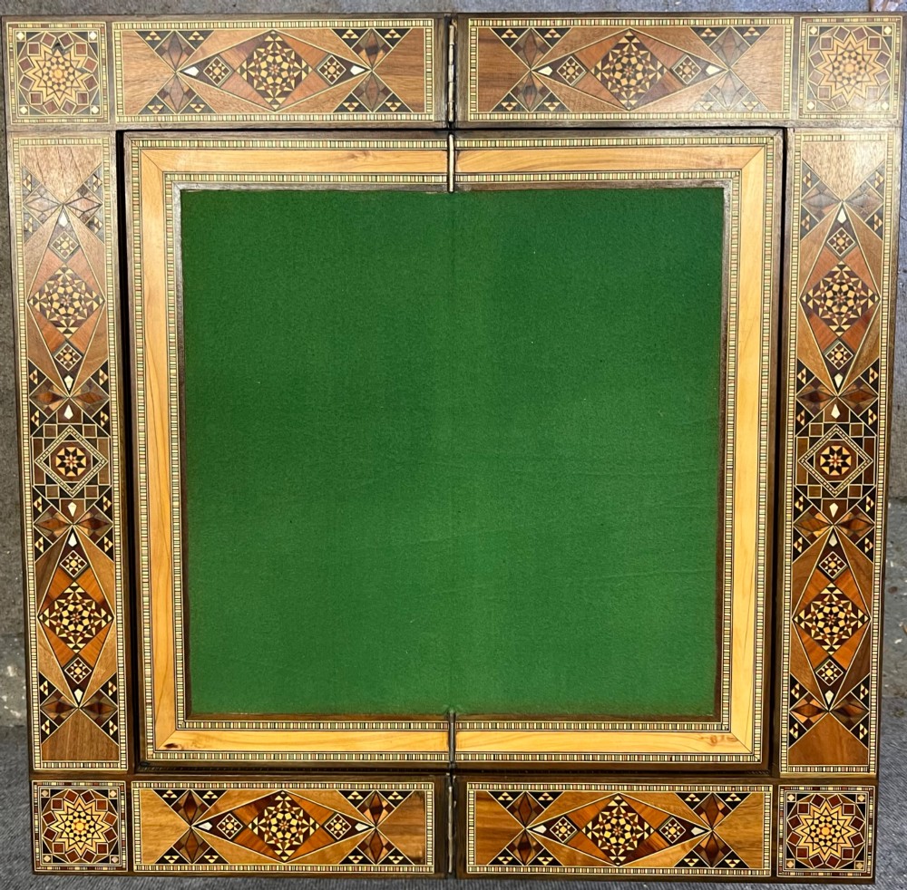 A Syrian games table featuring geometric micro-mosaic wood inlay, curved cabriole legs, and a fitted lower shelf. View VI